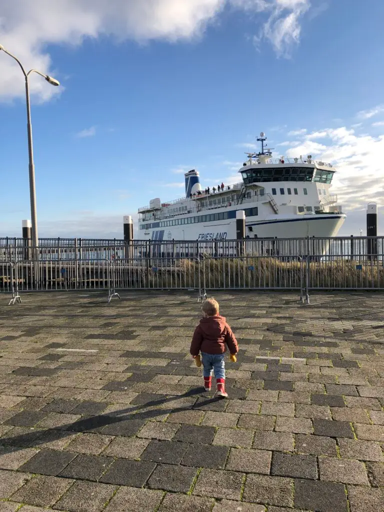 Kind kijkt naar de veerboot van Terschelling in de haven van West-Terschelling
