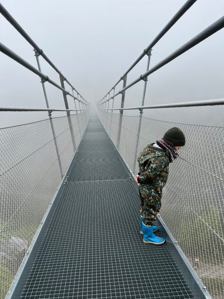 Kind loopt over de hangbrug Highline179 in Oostenrijk, net over de grens bij Duitsland