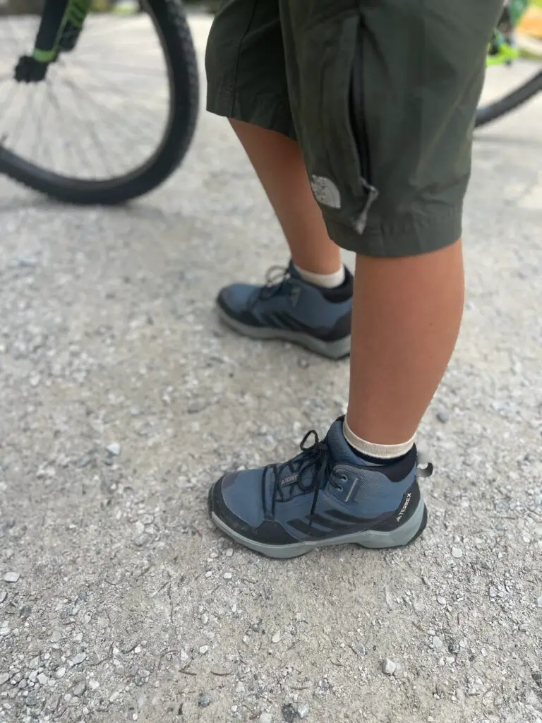 Adidas Terrex wandelschoenen van een kind aan tijdens een vakantie in de bergen met kinderen