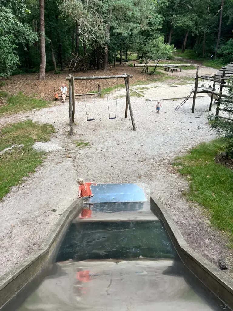 Uitzicht over de speeltuin in het Blauwe Bos vanaf de grote glijbaan